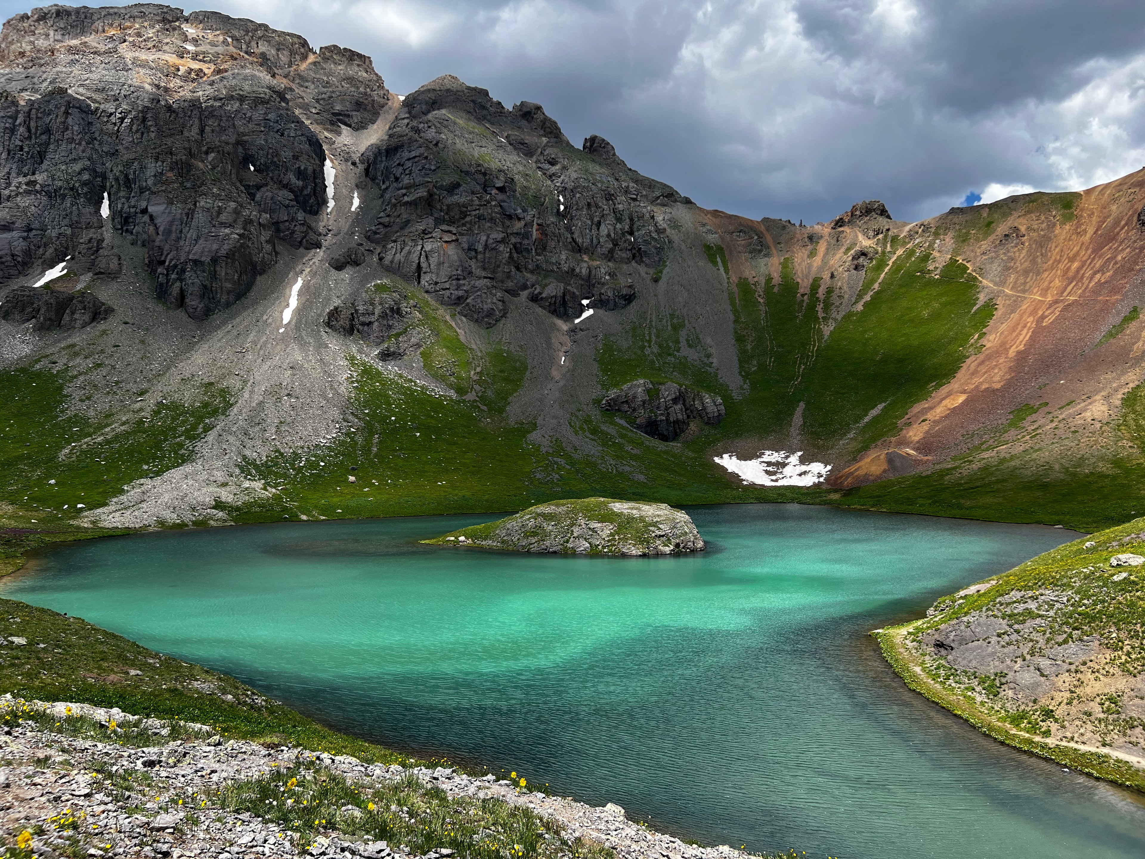 Island Lake reflecting towering San Juan peaks