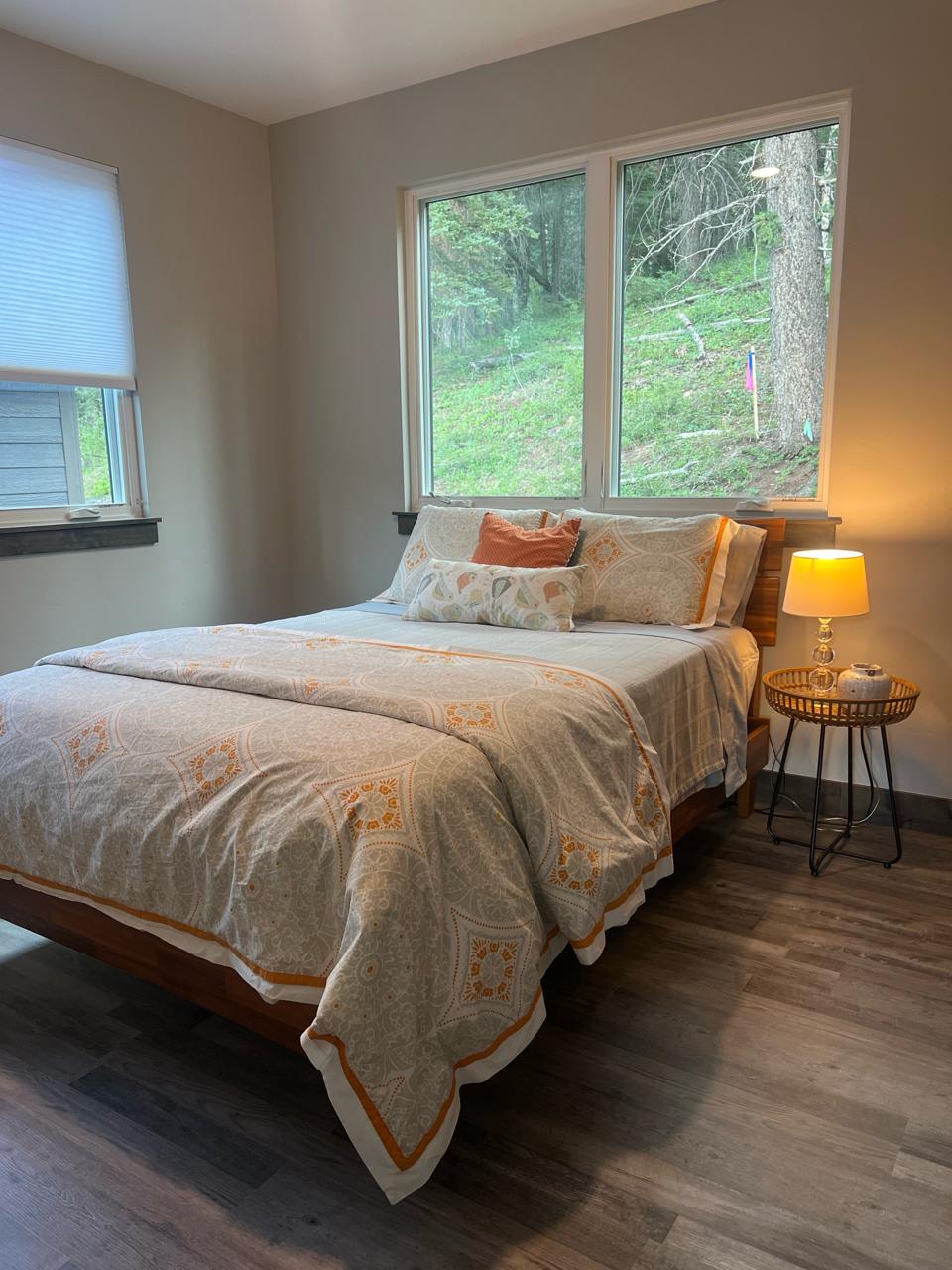 Guest bedroom — queen bed with orange duvet